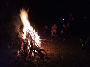 Group of trekkers enjoying a nighttime bonfire at a campsite in the Himalayas