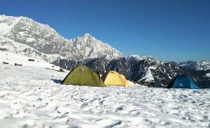 Winter camping tents in the snow-covered Dhauladhar mountains during a high-altitude trek