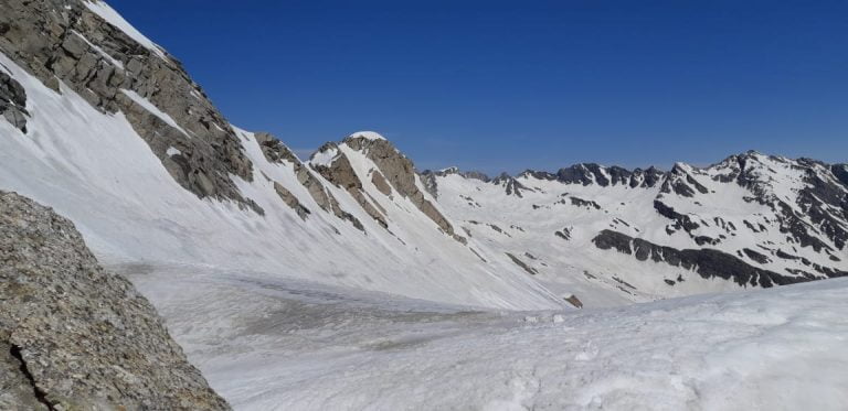 a snowy mountain range with blue sky