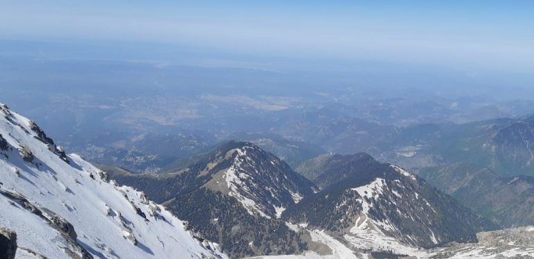 a mountain range with snow and trees