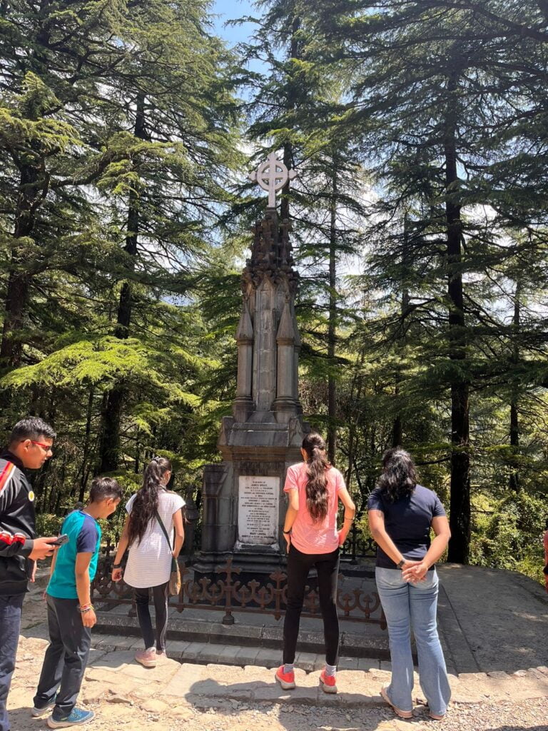 a group of people standing around a monument