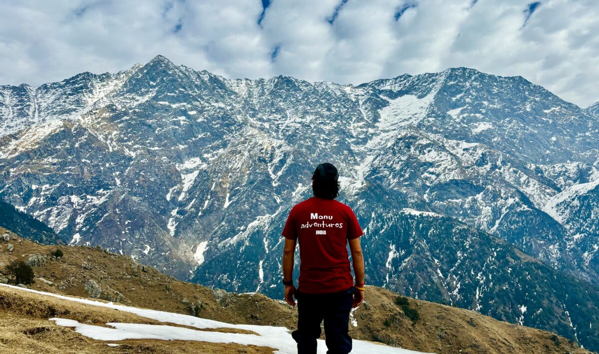 Trekking group at Indrahar Pass with snow-covered peaks in the background