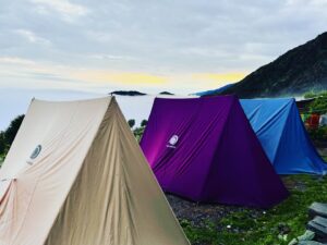 Colorful tents pitched at Leta campsite during a Himalayan family trek with Manu Adventures