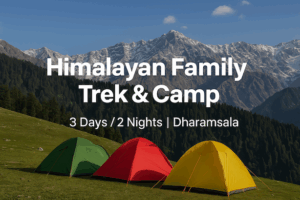 Family camping in Dharamsala with colorful tents and Himalayan backdrop