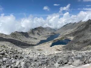 Lam Dal Lake surrounded by rocky Himalayan mountains in the Dhauladhar range, Himachal Pradesh.