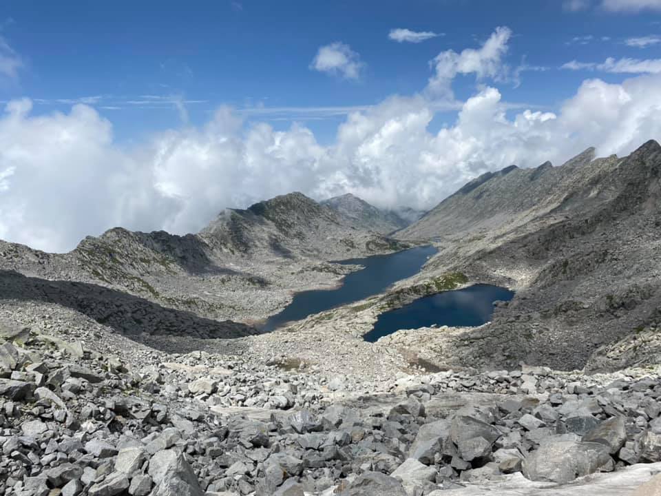 Lam Dal Lake surrounded by rocky Himalayan mountains in the Dhauladhar range, Himachal Pradesh.