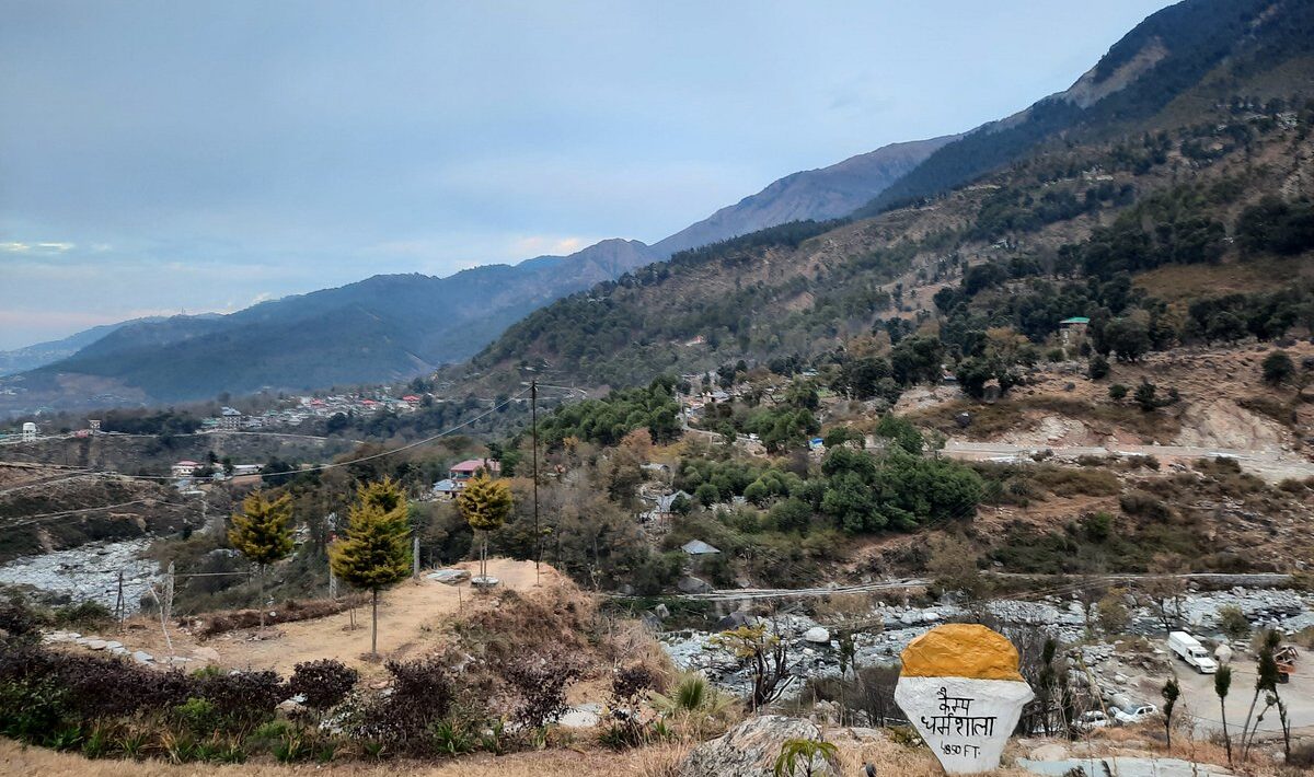Peaceful view of Kharota village near Dharamsala with mountain backdrop and river valley in Himachal Pradesh
